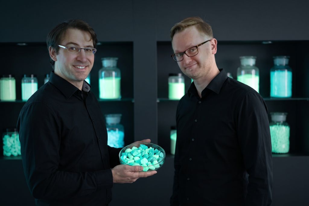 Dr Falko Böttger-Hiller and Lars Ehrhardt, managing directors of Lumentify GmbH, in the warehouse with a jar of glowing pigment