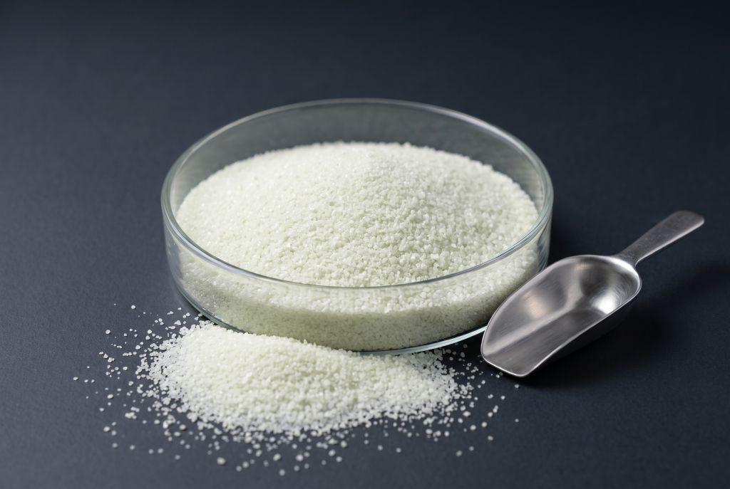 Glow granules (up to 1 mm) in a glass dish, green, in daylight